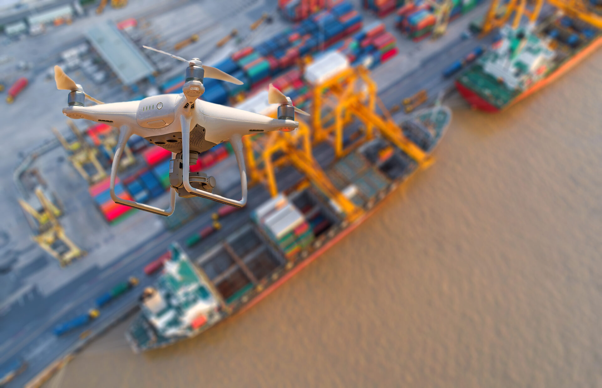 Drone flying over container ship in import export and business